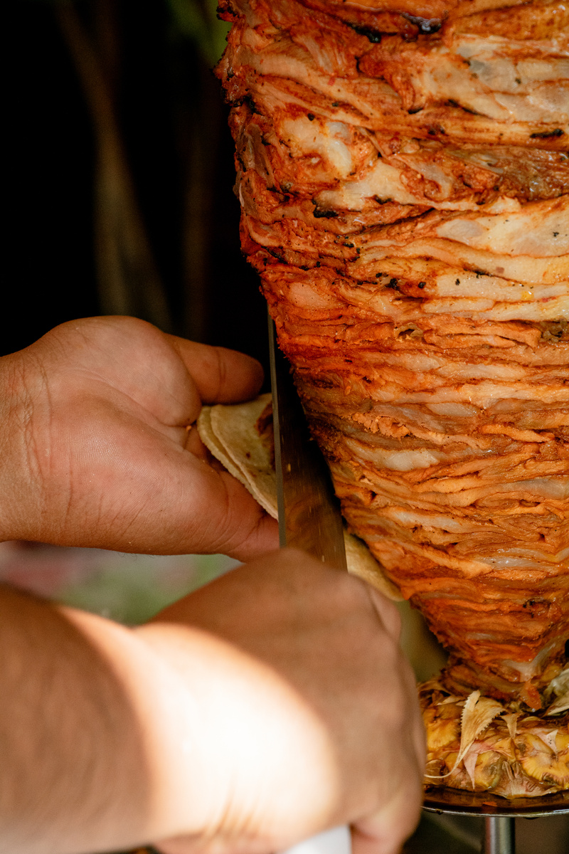 Man Cutting Trompo of Pastor Meat Close-up
